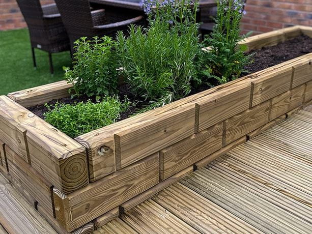 grooved wooden sleepers as planters