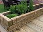 grooved wooden sleepers as planters