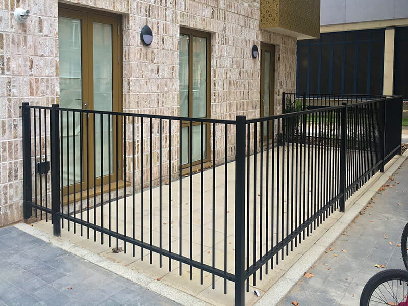 Flat top metal railings around housing