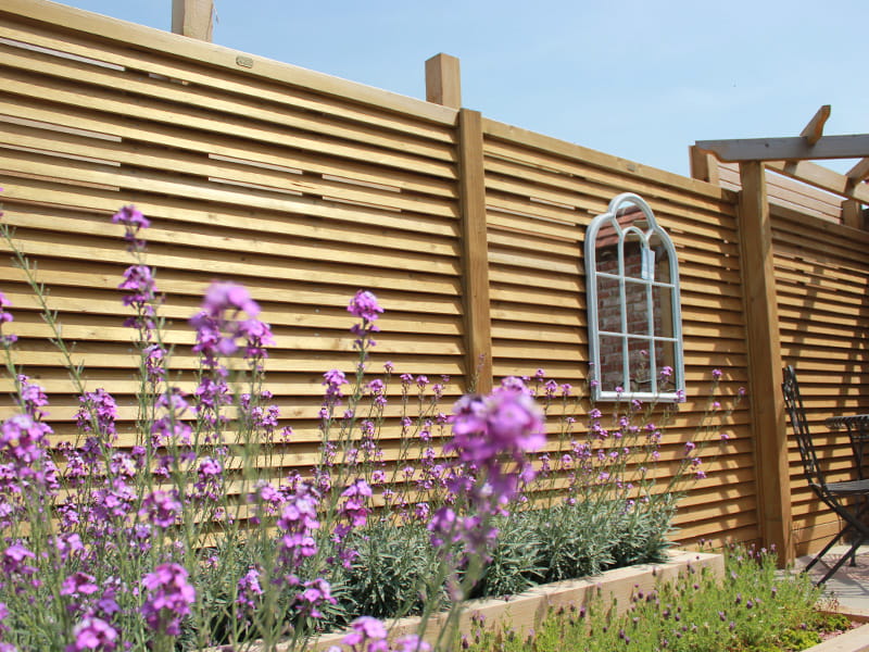 Angled slatted fence panels