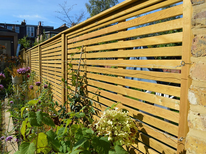 Slatted fence panels for wind prone gardens