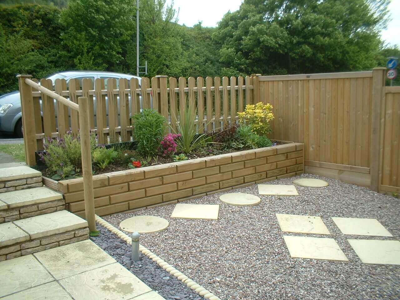 Front Jakwall flower bed with hit and miss palisade garden fence