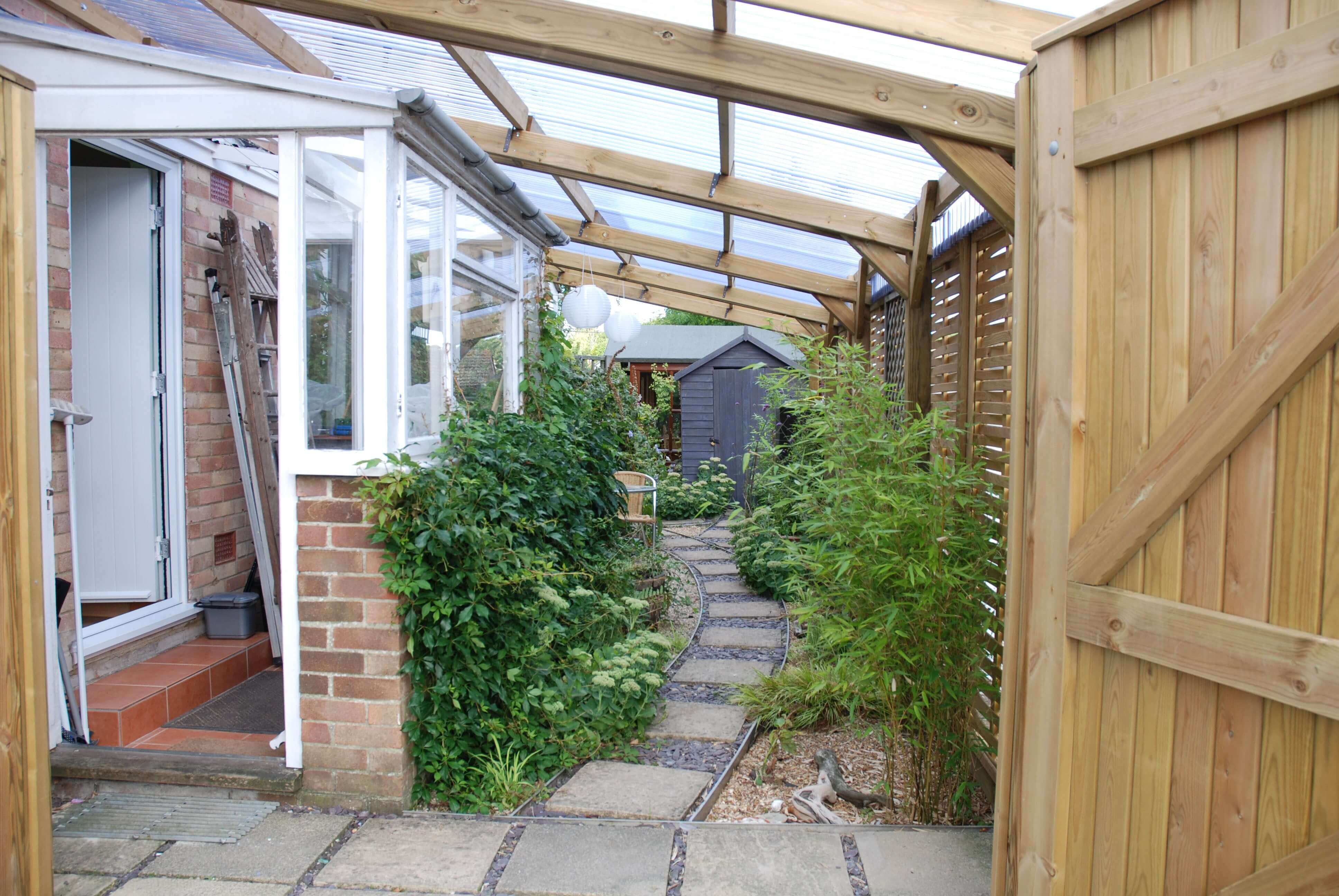 Pergola with plastic roofing on Woven fencing