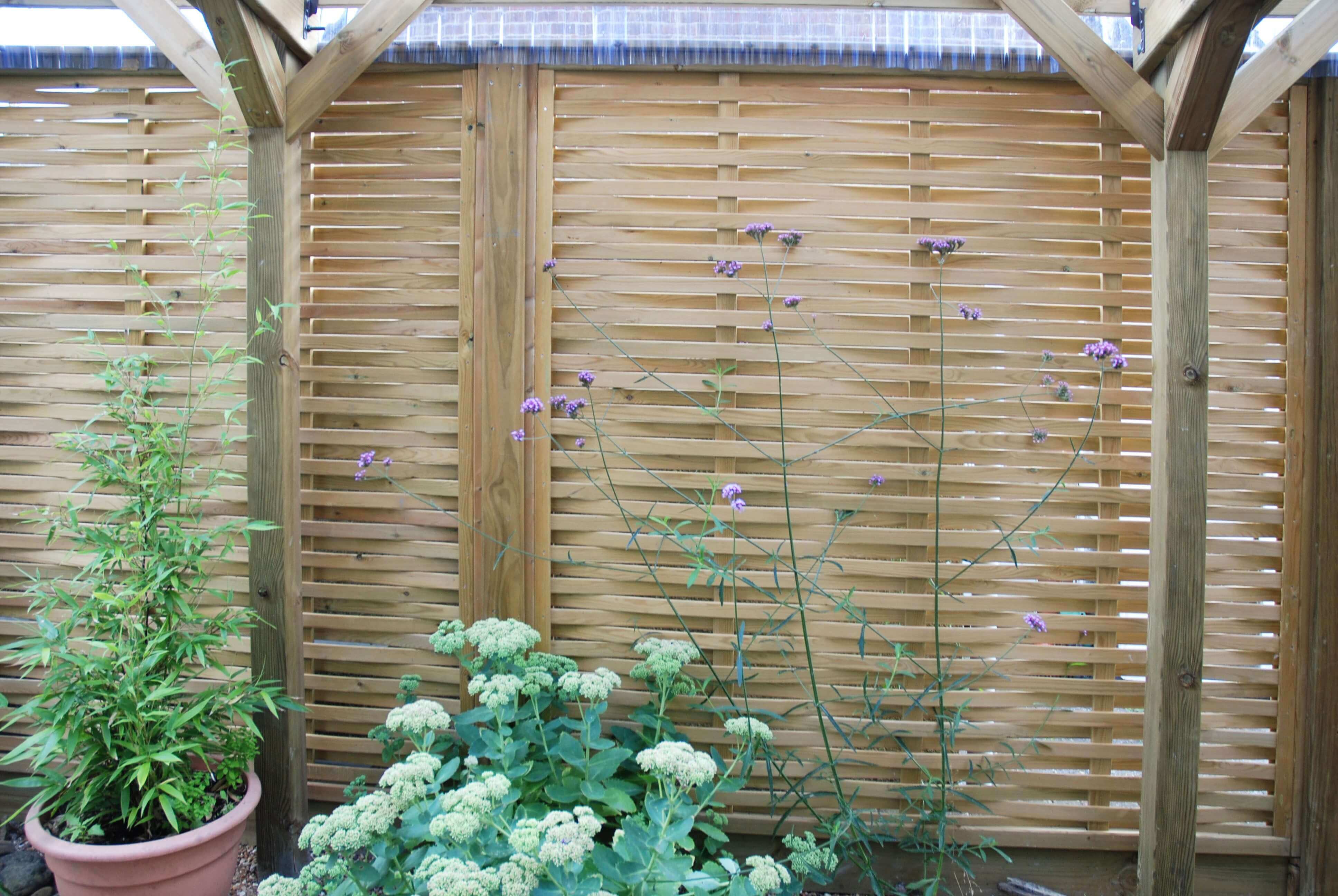 Woven fence panels along room side