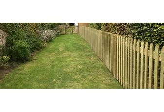 Traditional picket fence creates dog fence for garden
