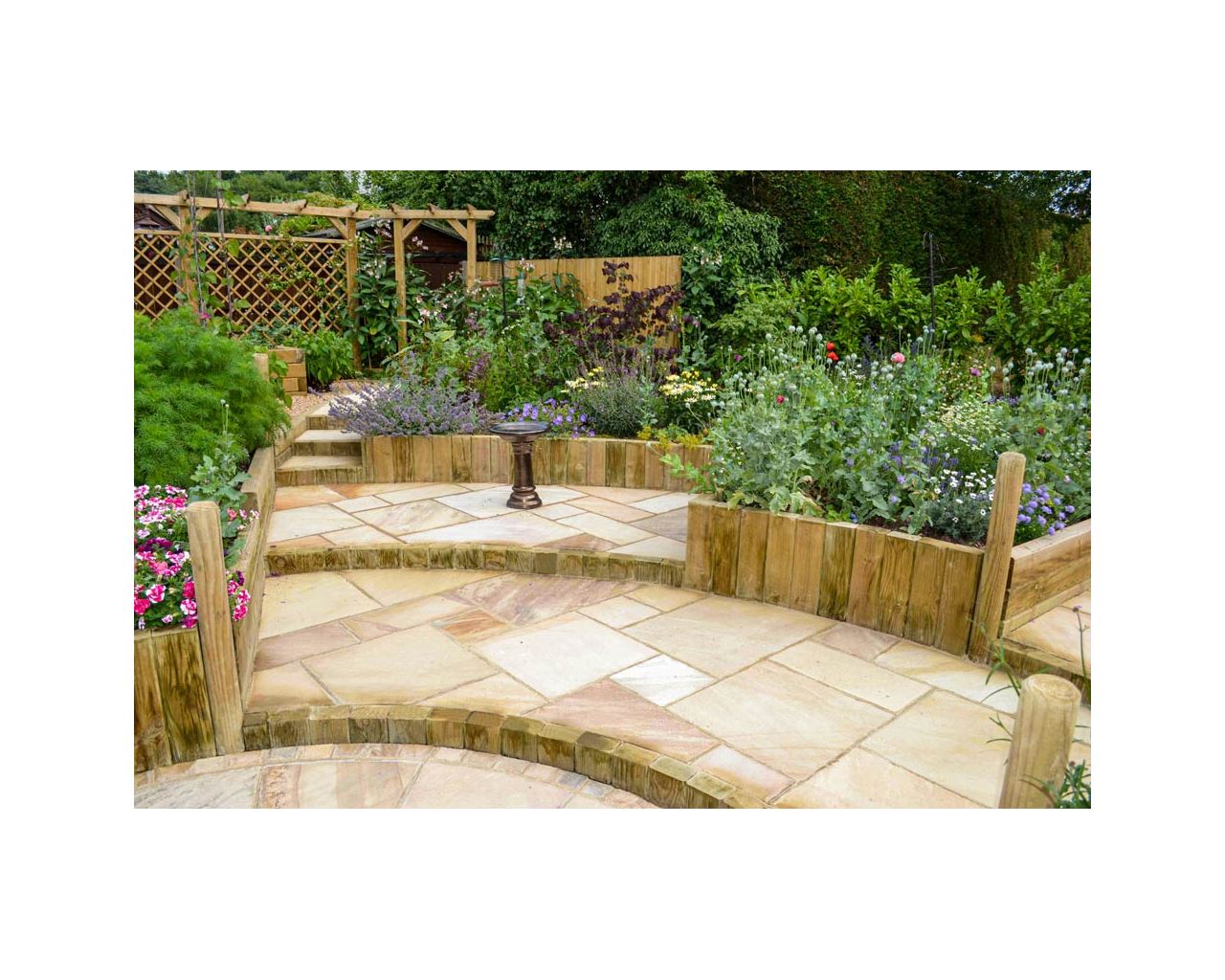 garden with steps from landscape timbers and single wooden pergola