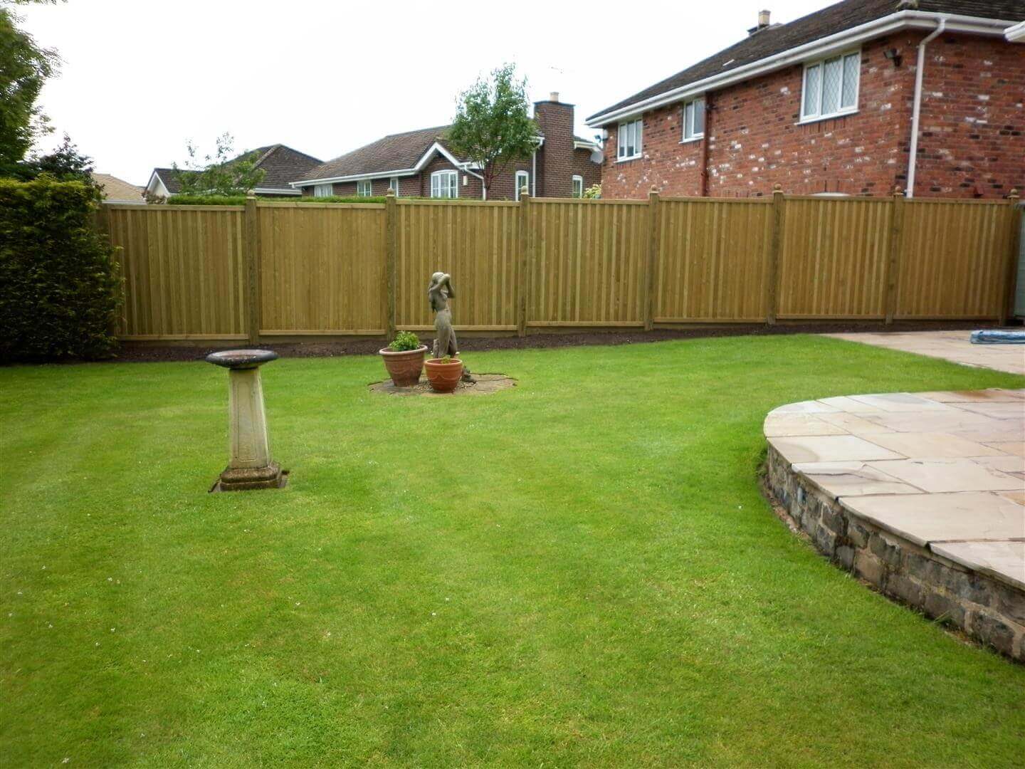 New Fence panels installed in garden compliment lawn