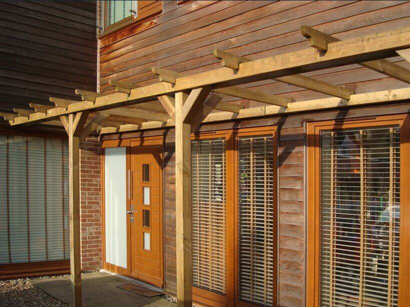 Wooden pergola on back of house