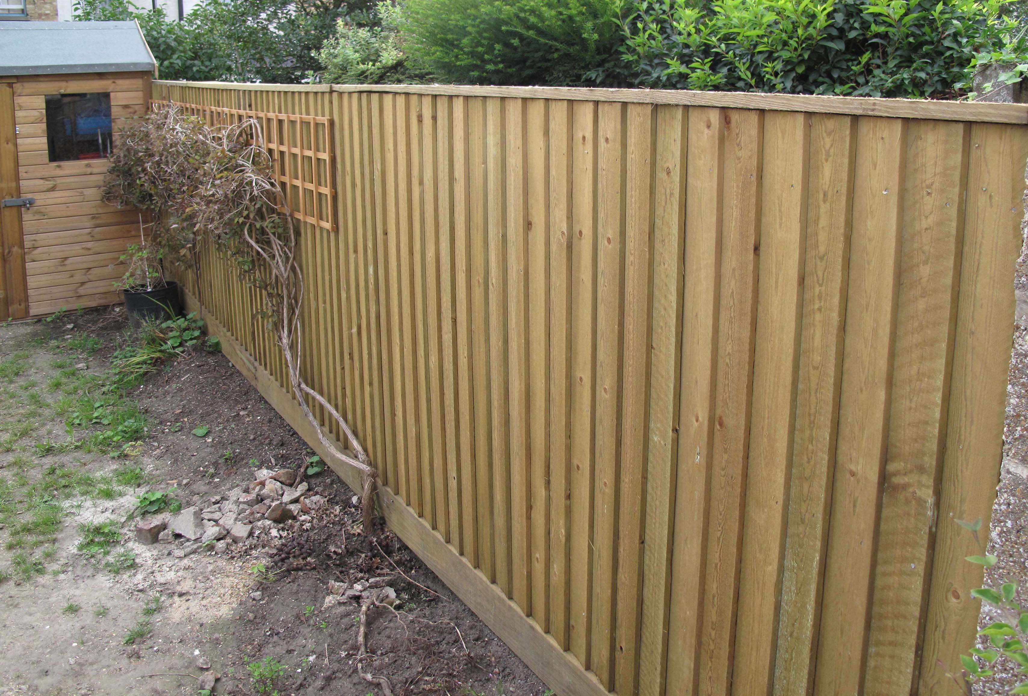 Featherboard clads old concrete fence