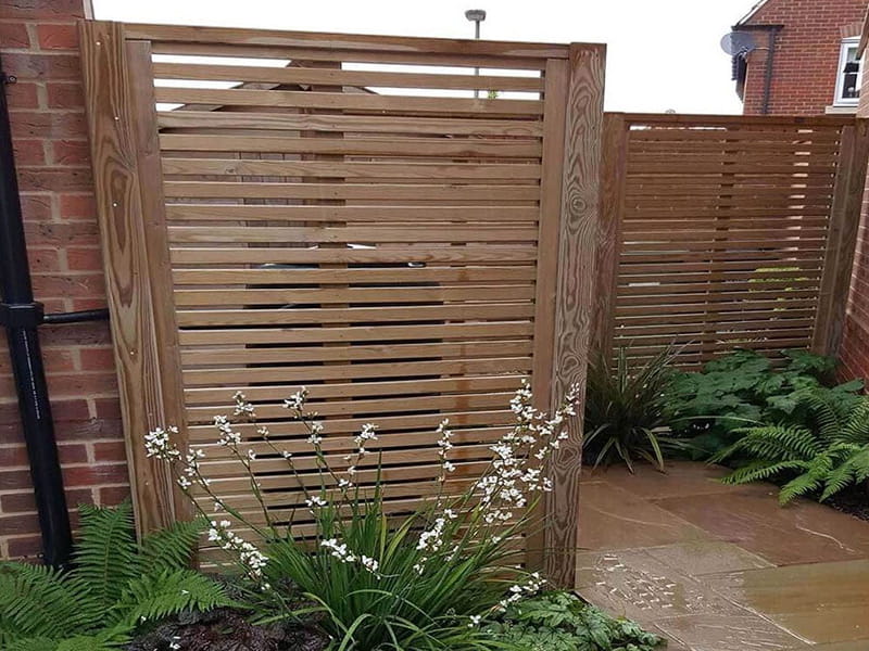 slatted fence hides bins