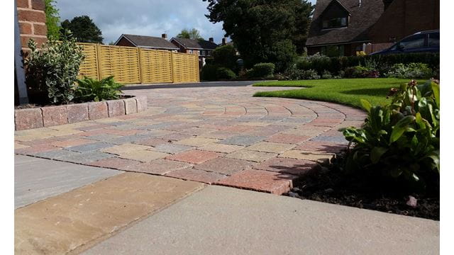 A drive with style paving and fence