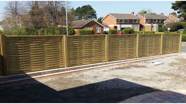 Woven fence panels installed on drive