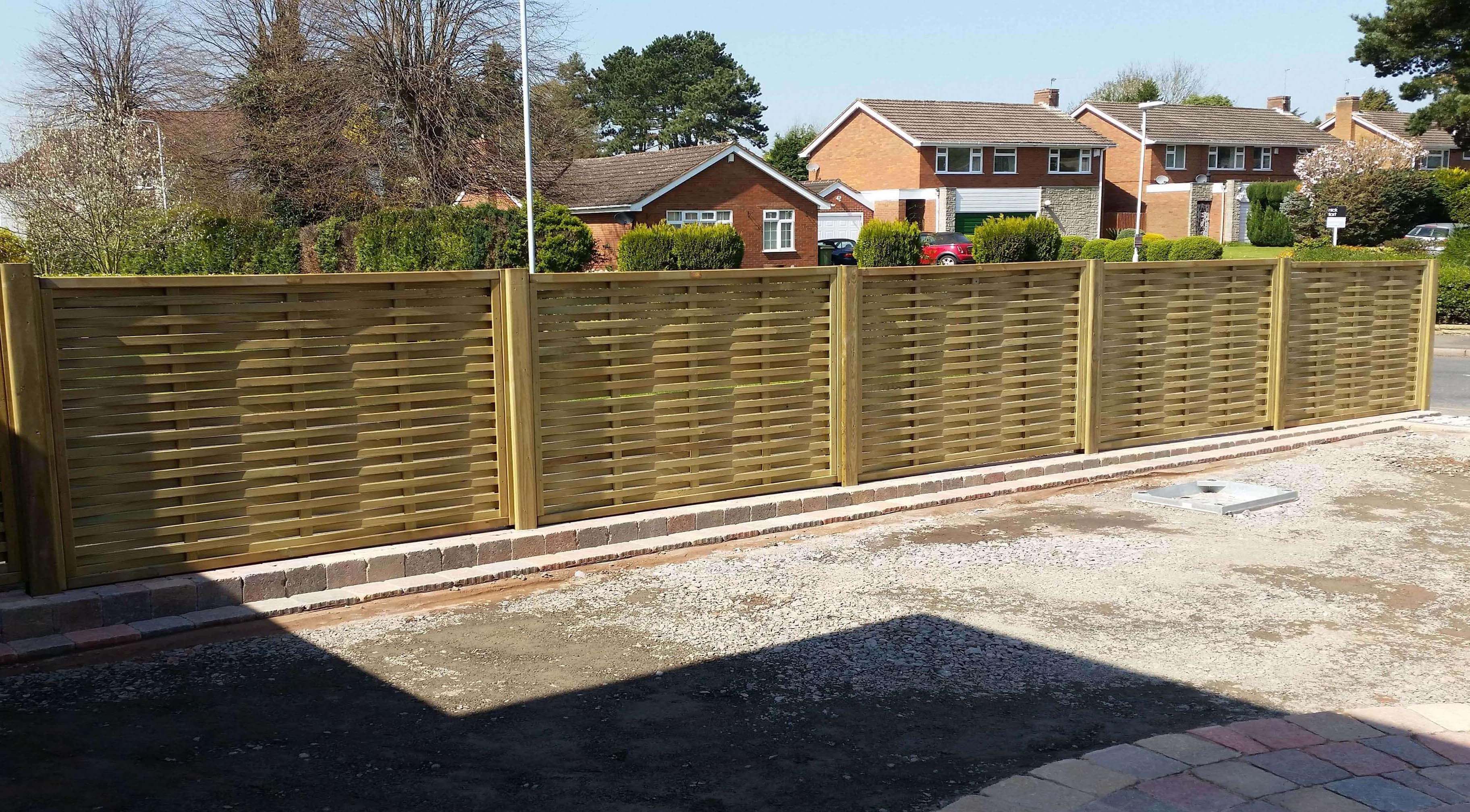 Woven fence panels installed on drive
