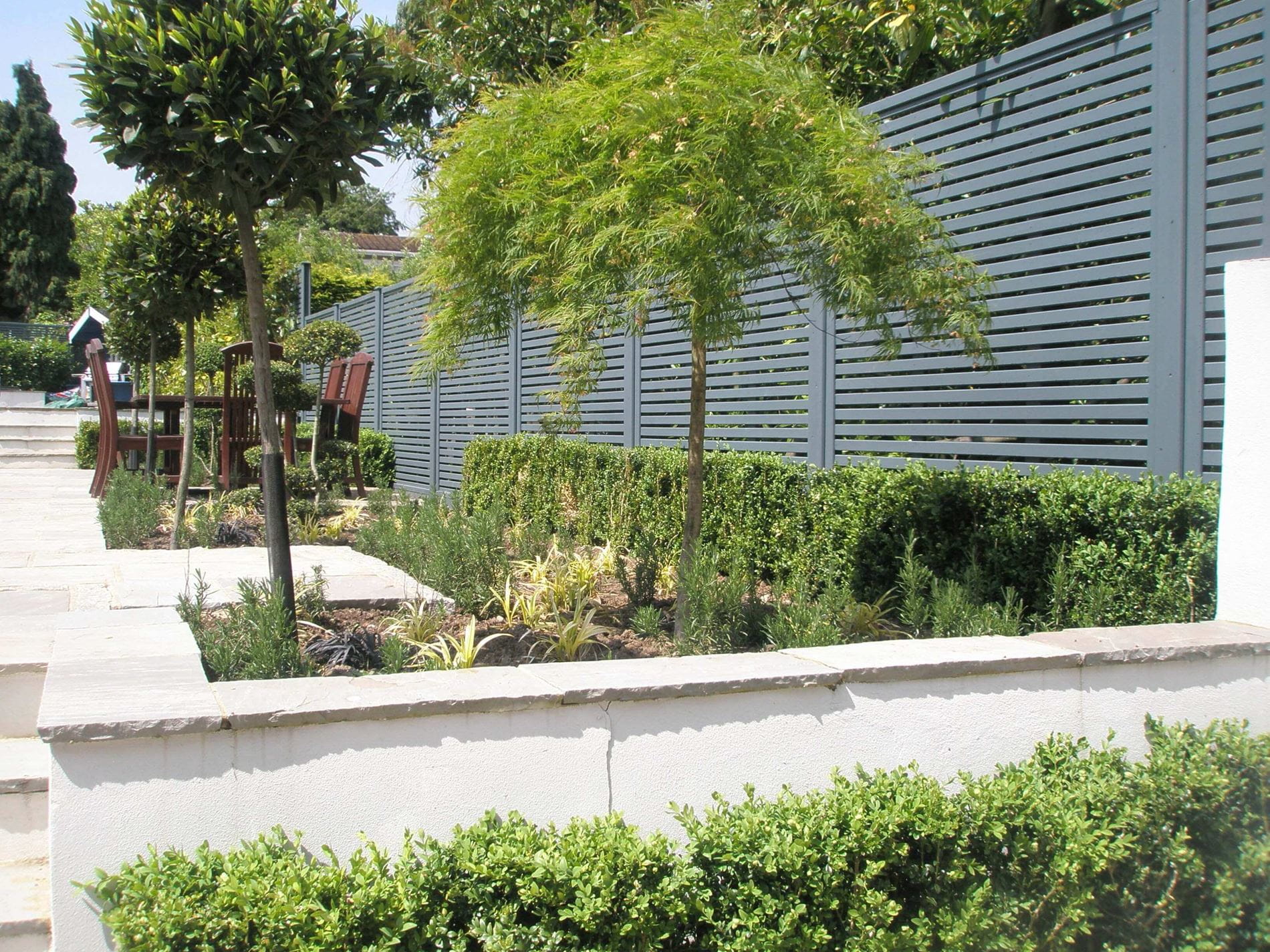 Venetian fencing separates garden