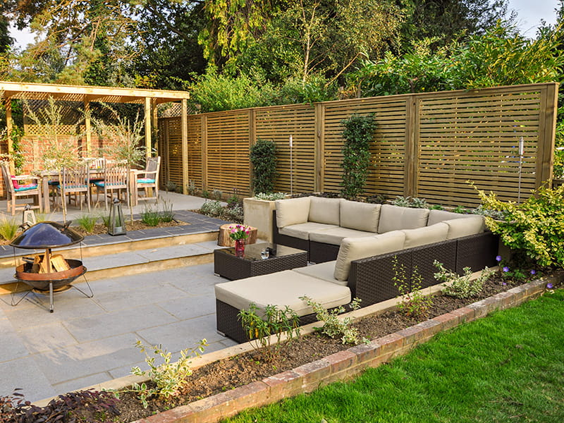 Slatted fence panels adding shade to garden