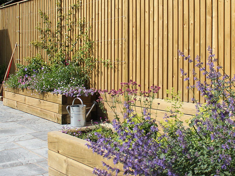 Featherboard fencing and sleeper raised beds