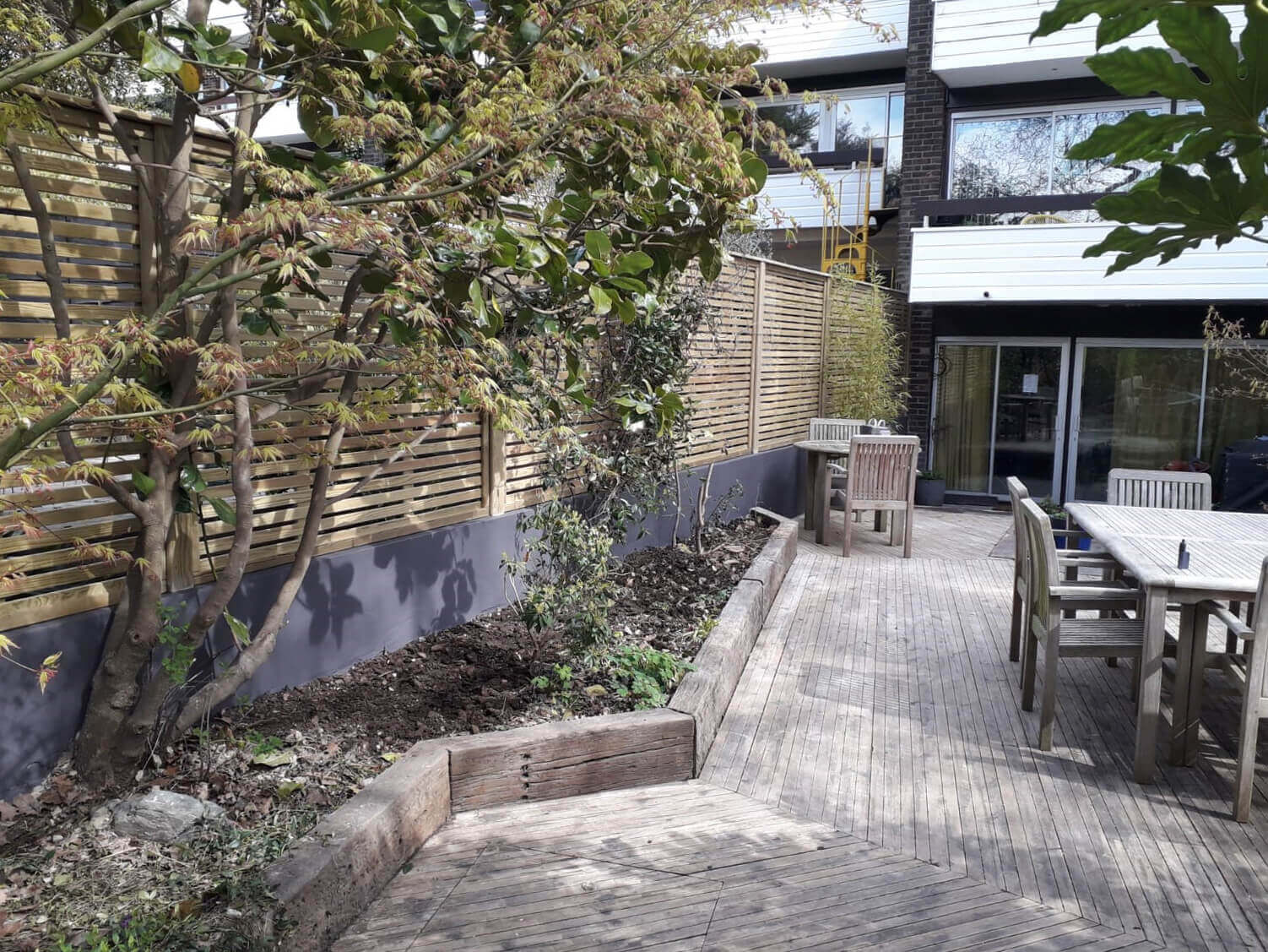 Contemporary Slatted Fence Panels Increase Sunlight In Garden