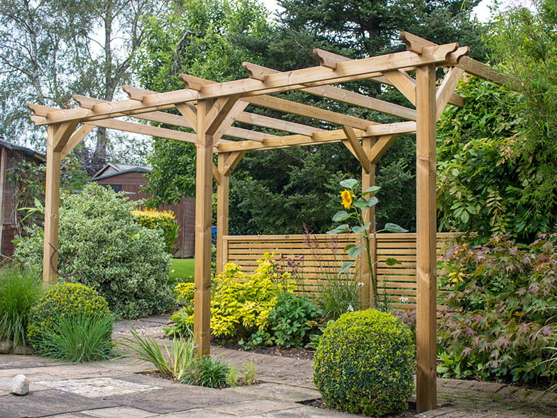 Wooden pergola with Venetian fence panels as garden screen