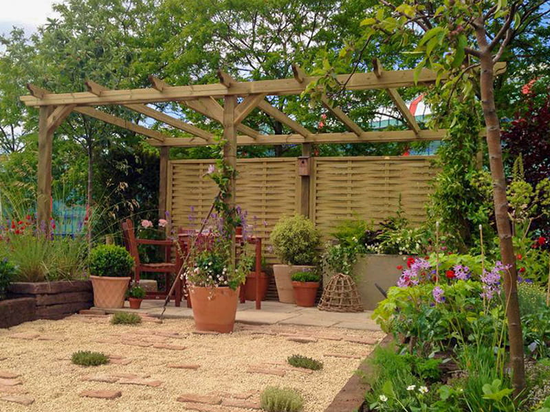 Wooden pergola with woven fence panels