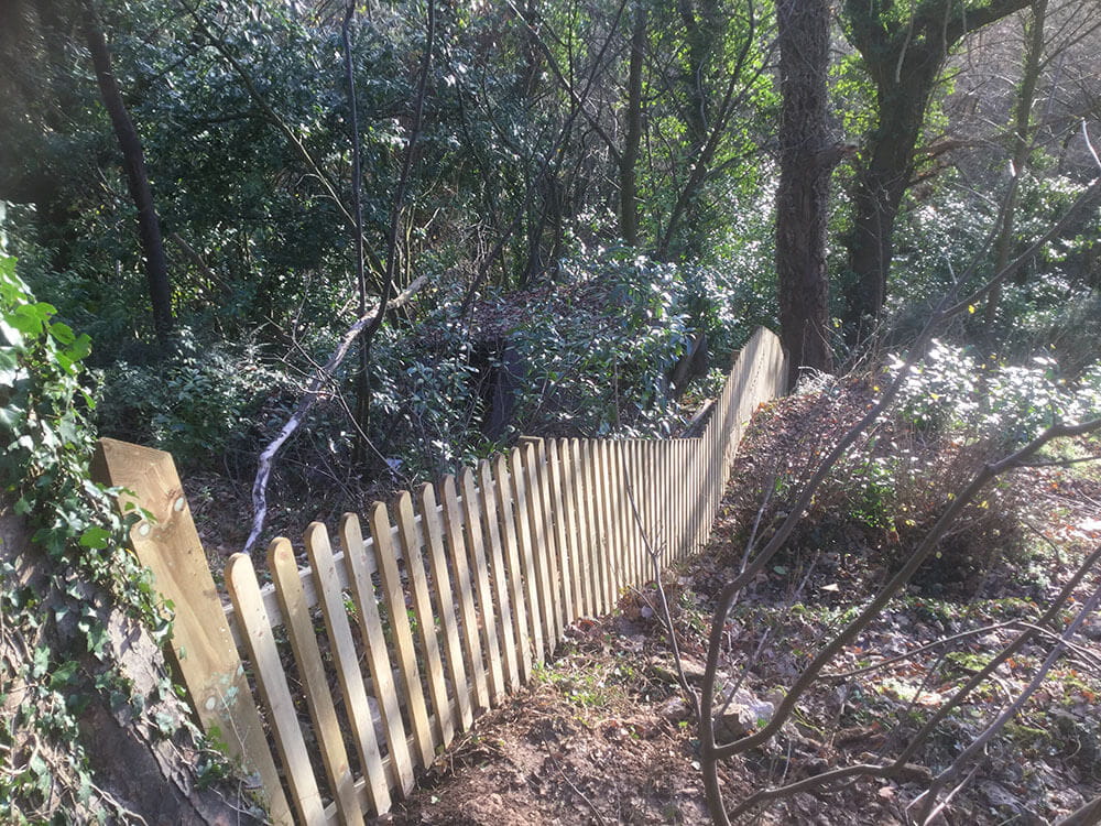 Kit form picket fencing on a hill