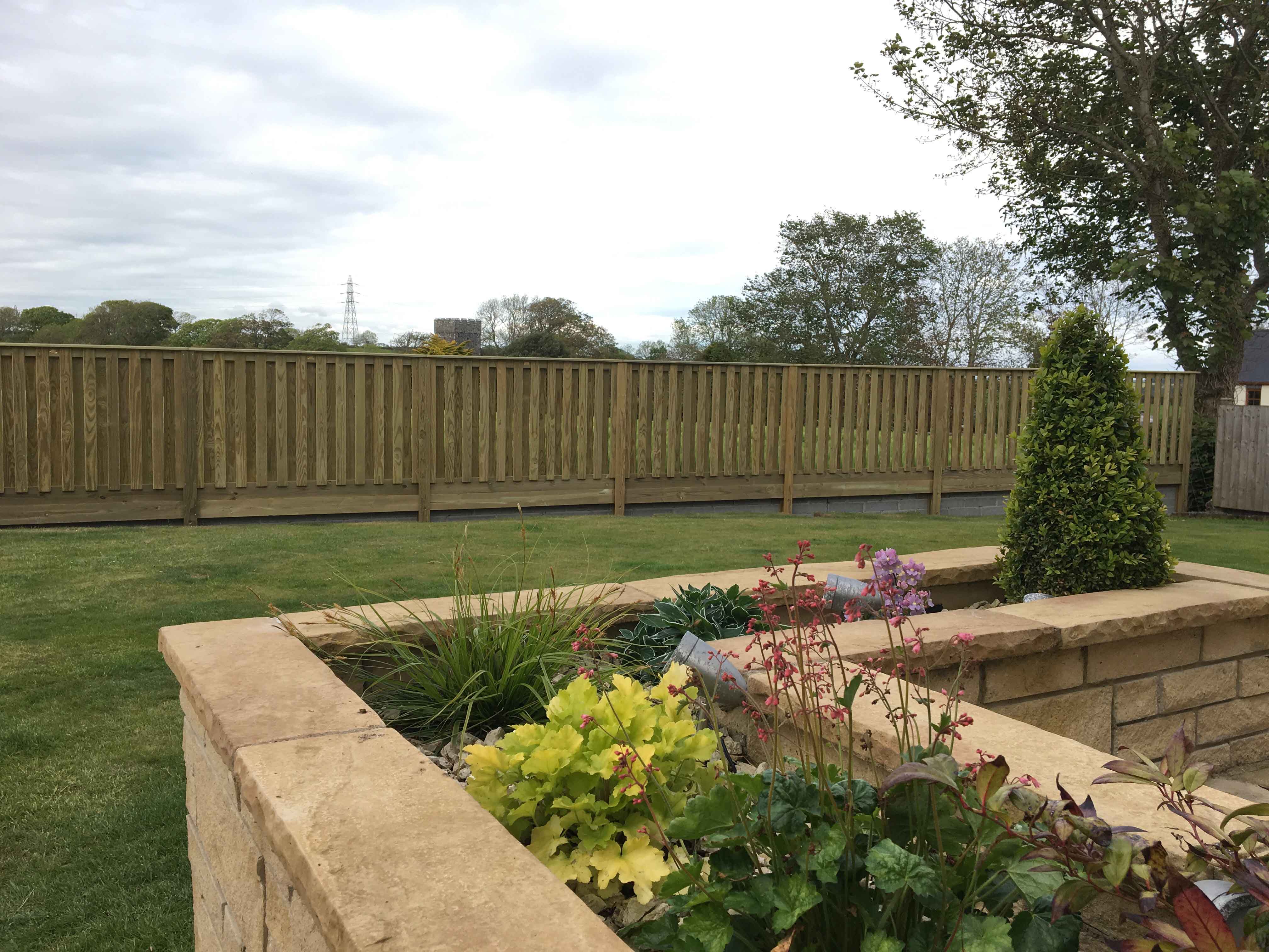 Wind resistant fencing protects rural family garden Jacksons Fencing