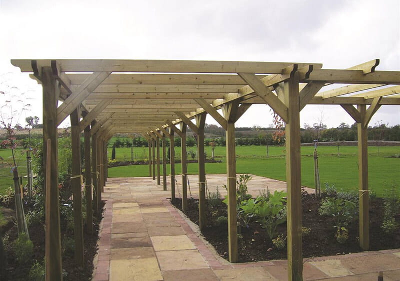 Install a pergola over a path to create a tunnel or walkway