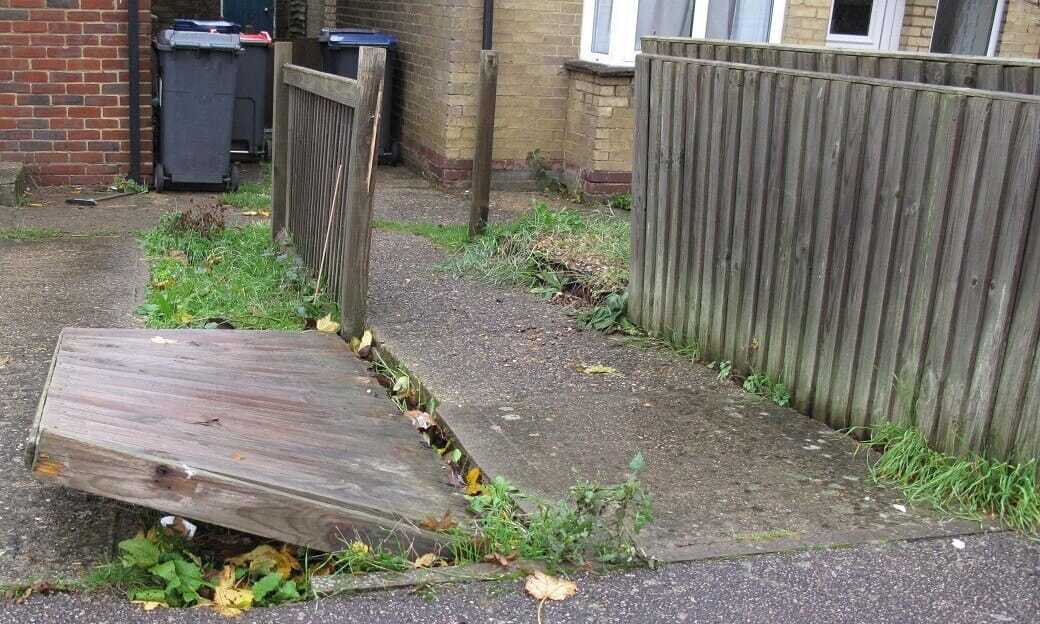 Storm damaged broken closeboard fence