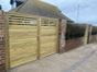 Double leaf garden gates protecting driveway