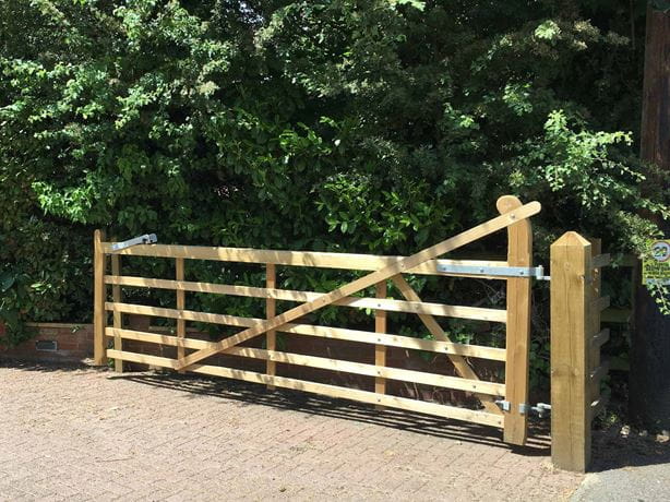 Traditional entrance gate covering driveway