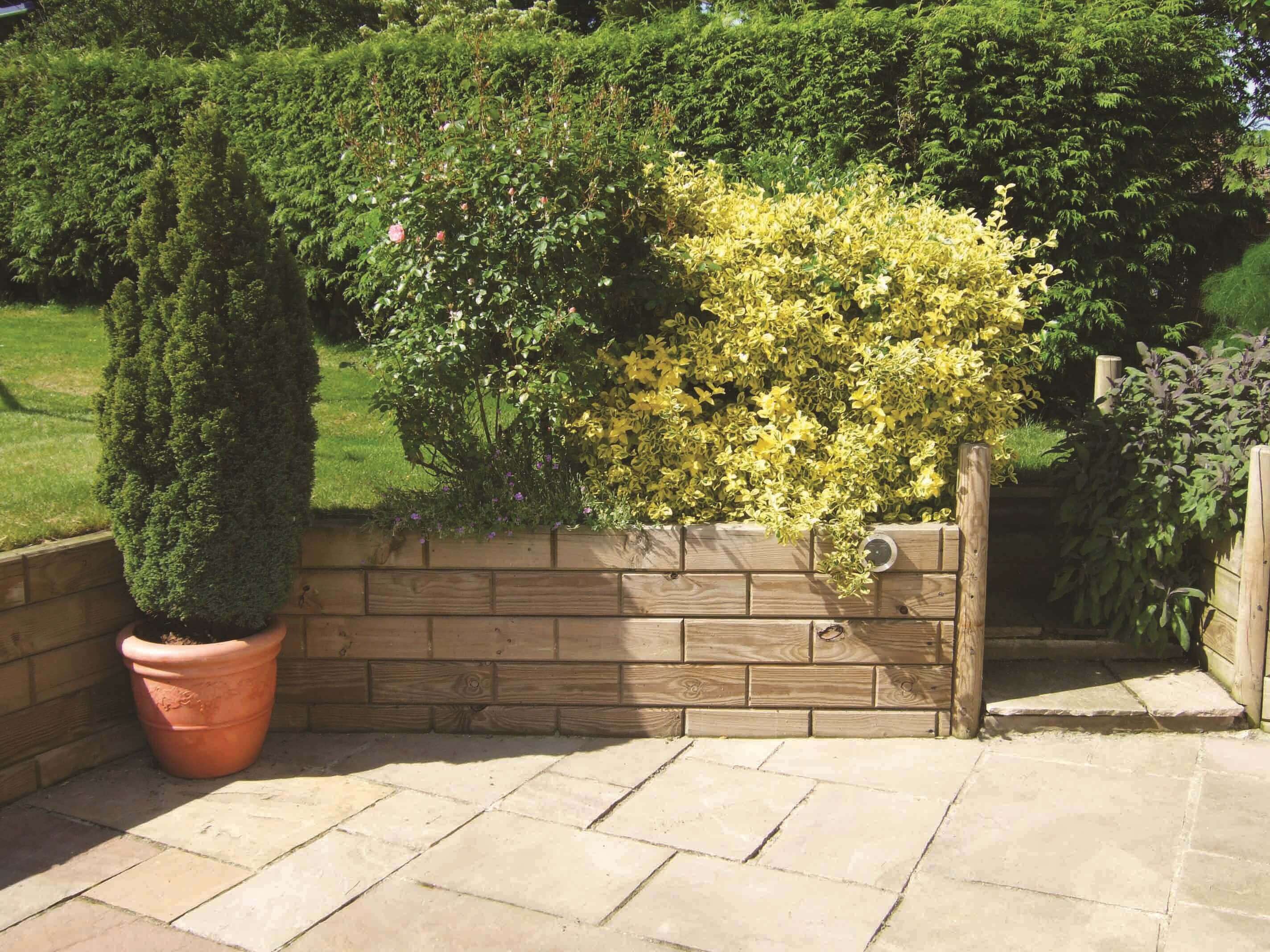 Timber block retaining landscape wall