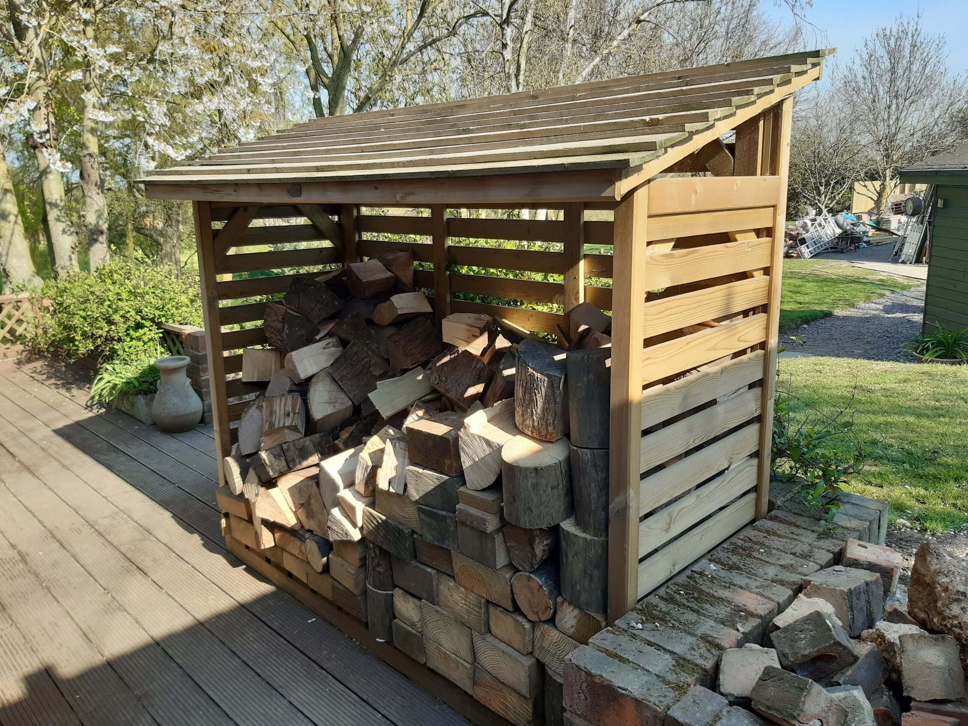 Timber roofed log store